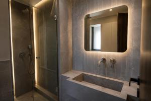 a bathroom with a sink and a mirror at Stella View in Pefki