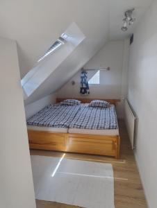 a bedroom with a bed in a attic at Apartmán Nebo in Turčianske Teplice