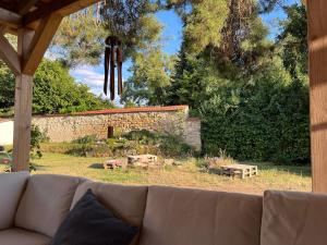 a couch sitting in a yard with a stone wall at Chalupa Hubina in Snědovice +51 photos