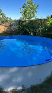 a large blue swimming pool in a yard at Chalupa Hubina in Snědovice