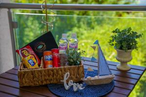 a picnic basket with drinks and a toy boat on a table at Modern Hammamet Stay Pool & Beach in Hammamet Sud