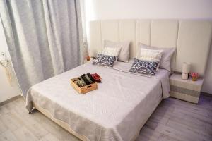 a bedroom with a bed with a basket on it at Modern Hammamet Stay Pool & Beach in Hammamet Sud +36 photos