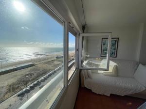 a bedroom with a view of the ocean from a window at Costa 010 in Setúbal +20 photos