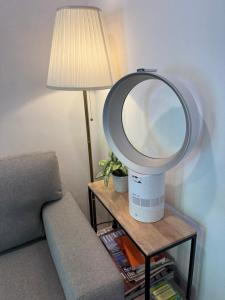 a mirror sitting on a table next to a couch at Modern cozy studio with backyard in Antwerp