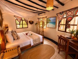 a bedroom with a bed in a room with windows at Tiki Beach Economy in Paje