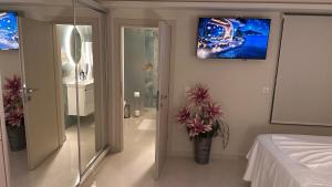 a bedroom with a bed and a painting on the wall at Sunset Suite Mytikas in Mytikas +57 photos