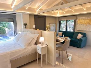 a bedroom with a bed and a dining room at Sunset Suite Mytikas in Mytikas