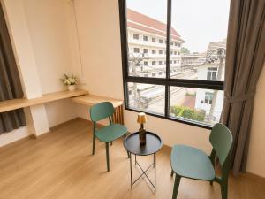 a room with two chairs and a table and a window at The 789 House in Chiang Mai
