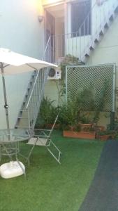 a patio with a staircase and a chair on the grass at Hotel Uruguay in Montevideo