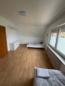 a bedroom with a bed and a wooden floor at Monterus Fürst in Fürstenau