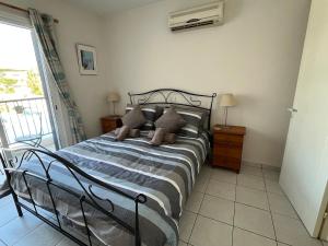 a bedroom with a bed with pillows on it at Pegeia Sun in Peyia +22 photos
