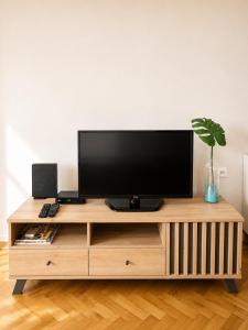 a wooden entertainment center with a flat screen tv on it at Apartman Lena in Belgrade