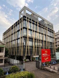 a large building with a sign in front of it at Hotel Serenity Suites in Nagpur