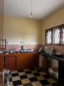 a kitchen with a counter with pots and pans at Oakville in Mysore