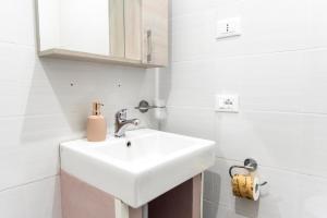a white bathroom with a sink and a mirror at Parri Silton in Rome +66 photos