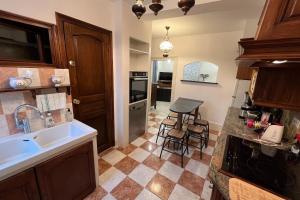 a kitchen with a sink and a counter at Logis du mont in Saint-Sernin-du-Plain