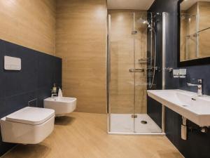 a bathroom with a shower and a toilet and a sink at Hotel Szara Willa in Opole +134 photos