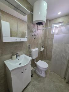 a bathroom with a toilet and a sink and a shower at Apartments Lati in Ulcinj +61 photos