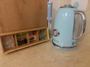 a blue appliance sitting next to a wooden shelf at Smart Home near beach and pool in Sharm El Sheikh