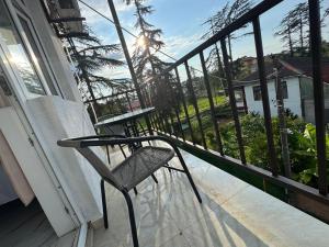 a chair sitting on the porch of a house at Chocolate in Ureki