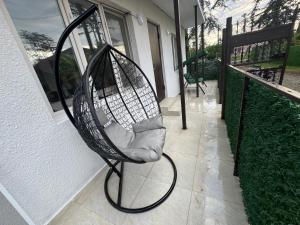a bird cage sitting on the side of a house at Chocolate in Ureki