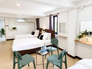 a room with two beds and a table and chairs at The 789 House in Chiang Mai +76 photos