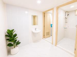 a bathroom with a sink and a toilet and a plant at The 789 House in Chiang Mai