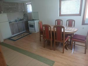 a kitchen and dining room with a table and chairs at Apartman BelSa in Sarajevo