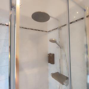 a shower with a glass door and a shower head at Casa Iris in Somma Lombardo +30 photos