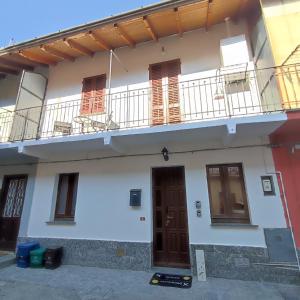 a white building with windows and a balcony at Casa Iris in Somma Lombardo