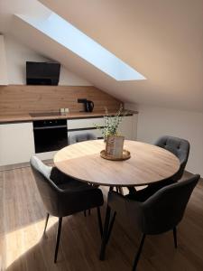 a dining room with a wooden table and chairs at Apartma Julia in Semič