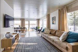 a living room with a couch and a table at Joulupukin talolla in Rovaniemi