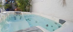 a jacuzzi tub with a water fountain at Appartement Jardin et Spa in Valras-Plage