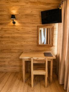a wooden room with a table with a laptop on it at J Villa Sigiriya - Private Pool Chalets in Dambulla
