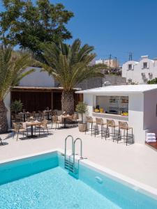 a villa with a swimming pool and a restaurant at Breaq Santorini - Margarita Hotel in Firostefani