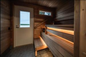 a wooden cabin with a door and a window at Joulupukin talolla in Rovaniemi +29 photos