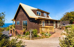a house with a gambrel roof at Ocean Views 20kms from CBD Sleeps 10 in Kingston Beach