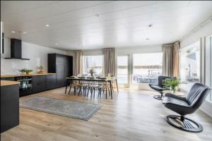 a kitchen and living room with chairs and a table at Joulupukin talolla in Rovaniemi