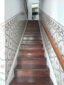 a flight of stairs with tiles on the wall at Casa Kilowatt - Amarante - Quarto 2 in Amarante
