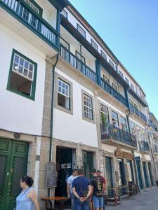 a group of people standing outside of a building at Casa Kilowatt - Amarante - Quarto 2 in Amarante