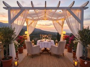 a table and chairs on a balcony with a view at Zone Guest House Bellapais in Kyrenia +13 photos