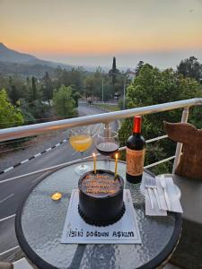 a table with a cake and two glasses of wine at Zone Guest House Bellapais in Kyrenia