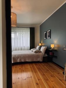 a bedroom with a bed and a window at The Forest room in Ikšķile