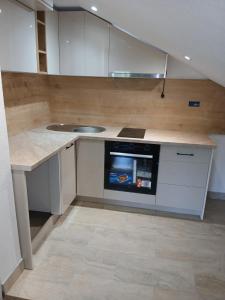 a kitchen with a sink and a dishwasher at Apartman Nature in Konjic