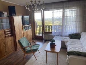a living room with a bed and a table and a chair at Panorama Hause in Podplat