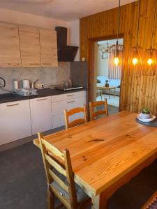 a kitchen with a wooden table and a dining room at Panorama Hause in Podplat