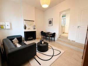 a living room with a couch and a table at Maison de ville hypercentre Béthune in Béthune