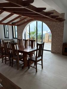a dining room with a wooden table and chairs at LasaThea in Lasa
