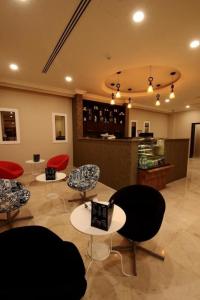 a room with chairs and tables in a store at شقق الآجنحة التنفيذية للشقق المخدومة in Riyadh