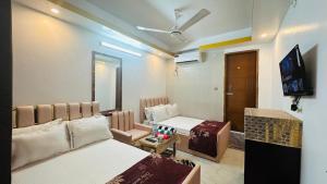 a room with two beds and a tv in it at Hotel New Kalabagan in Dhaka +67 photos